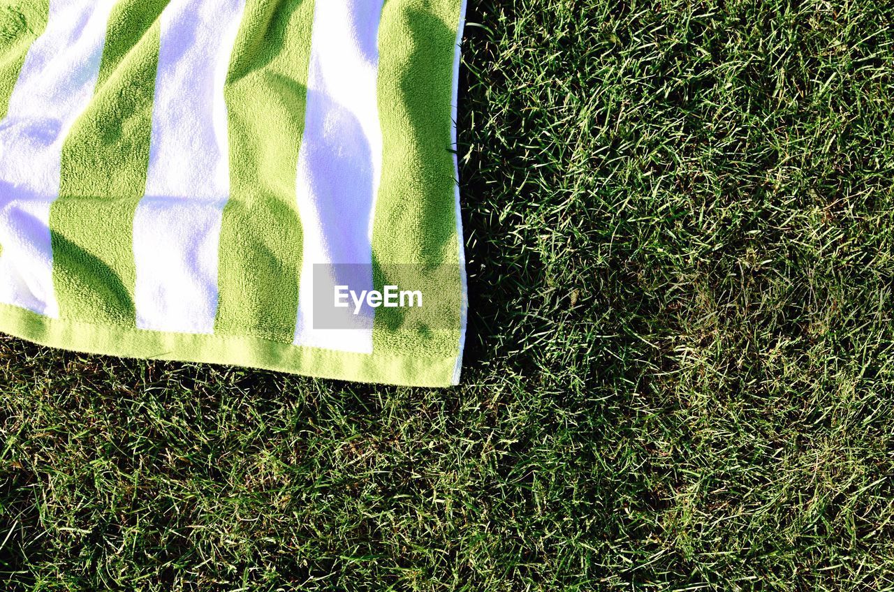 High angle view of towel on grassy field