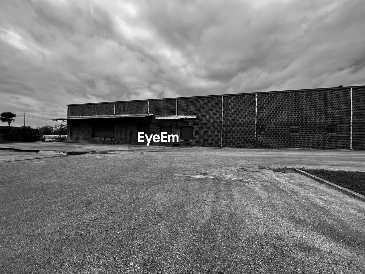 architecture, cloud, sky, built structure, monochrome, building exterior, black and white, transportation, no people, monochrome photography, nature, hangar, building, outdoors, industry, day, sport venue, road, city, black, white