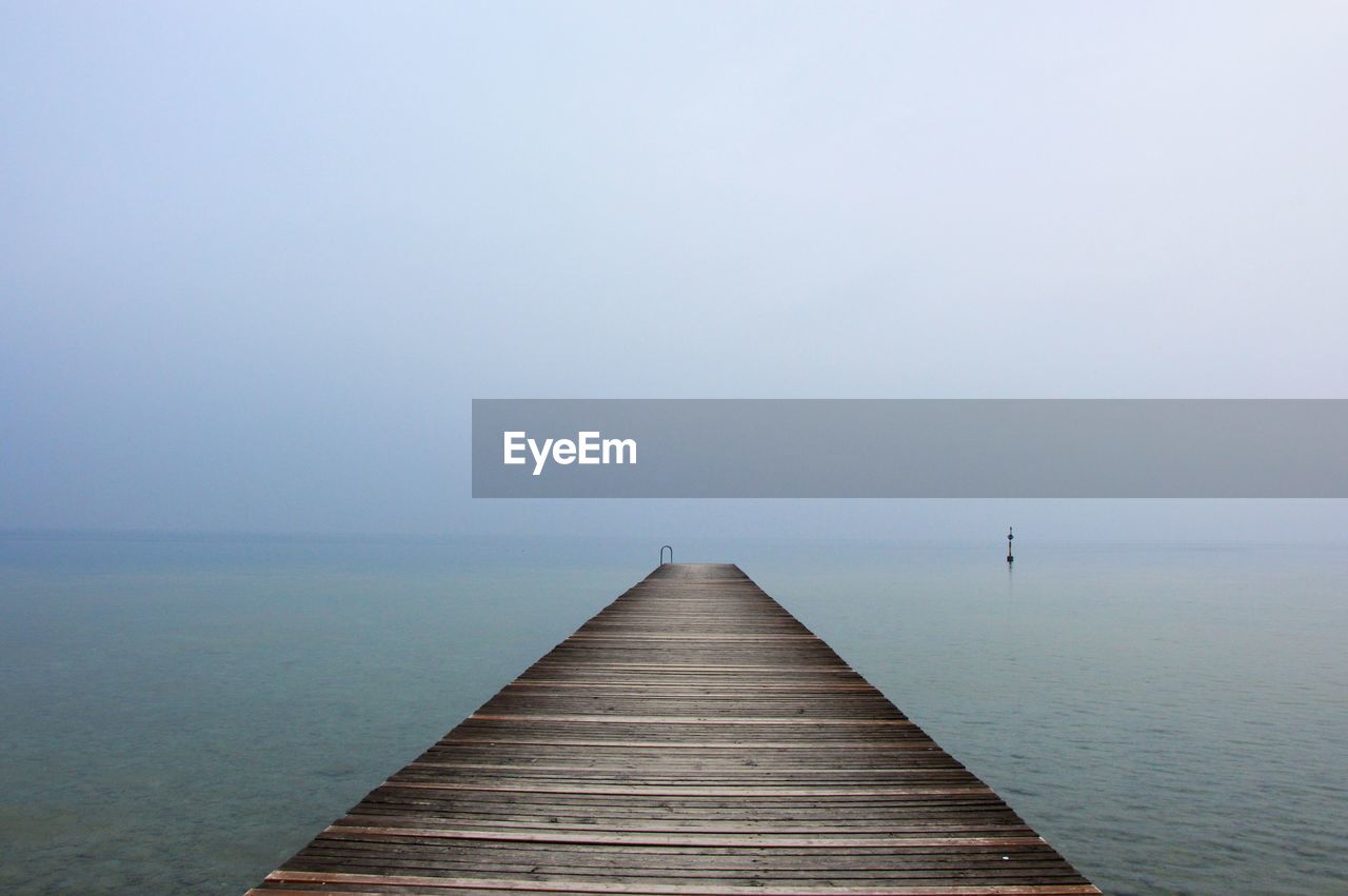 Pier over sea against sky