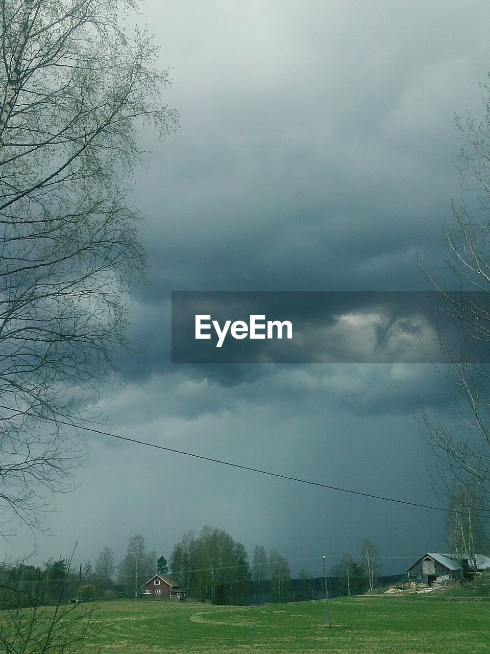 SCENIC VIEW OF STORM CLOUDS OVER GRASS