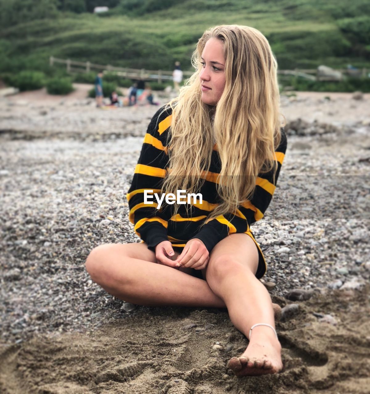 Full length of woman sitting at beach