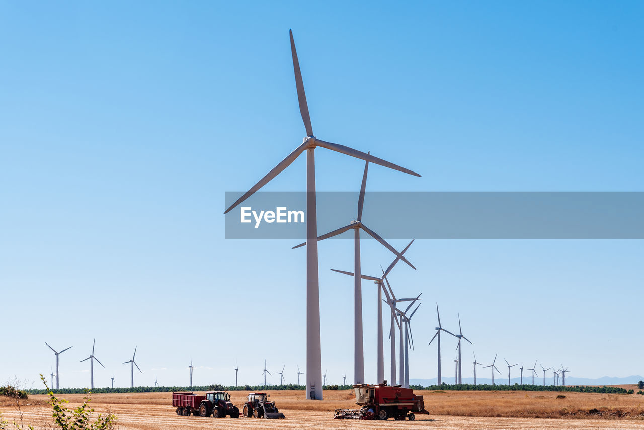 Wind turbines on landscape of farmland. clean energy and renewable energy concepts