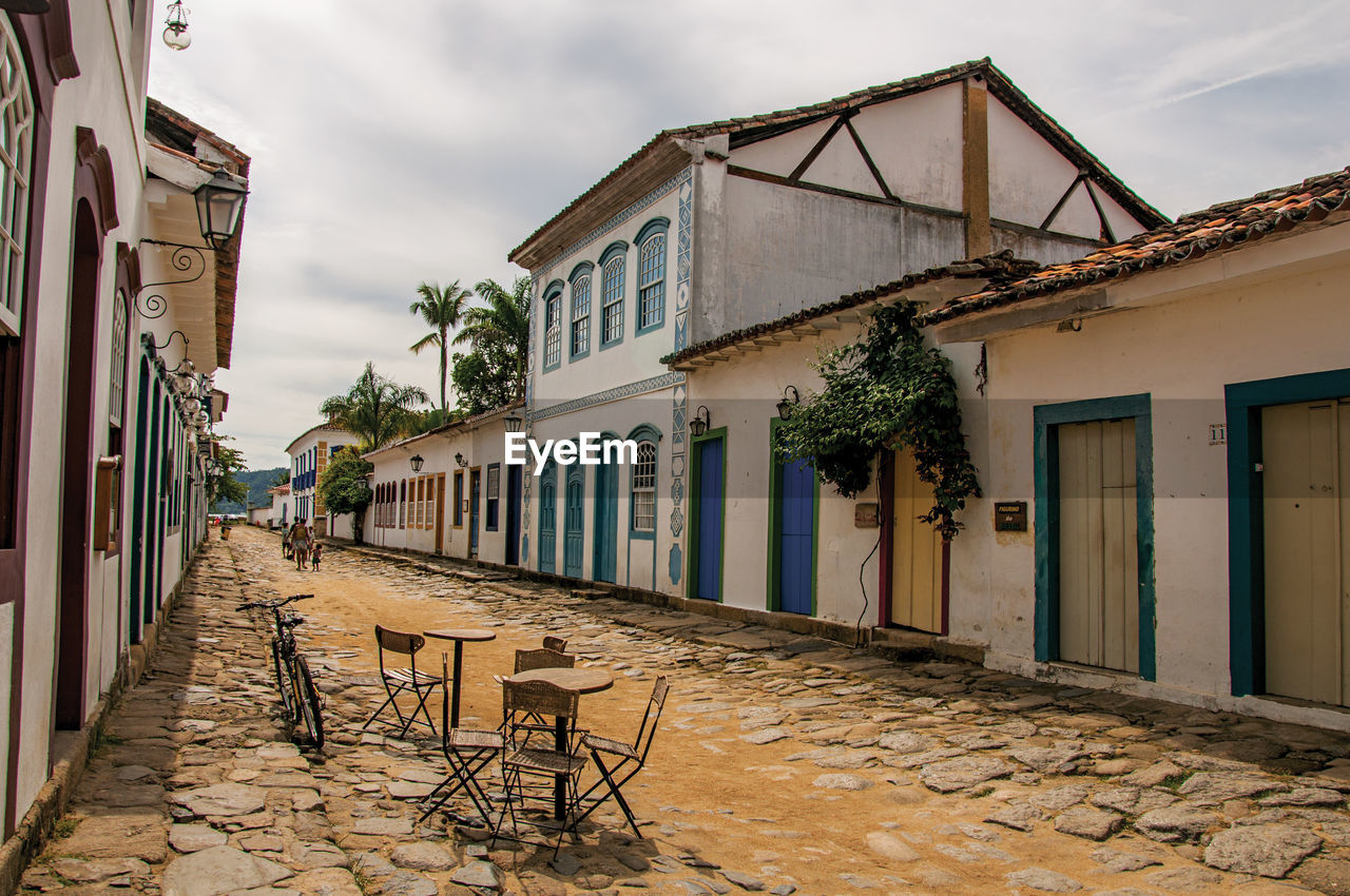 Overview of cobblestone street with old houses under cloudy sky in paraty, brazil