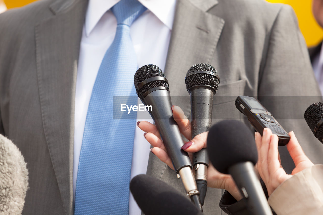 Cropped image of journalist interviewing businessman