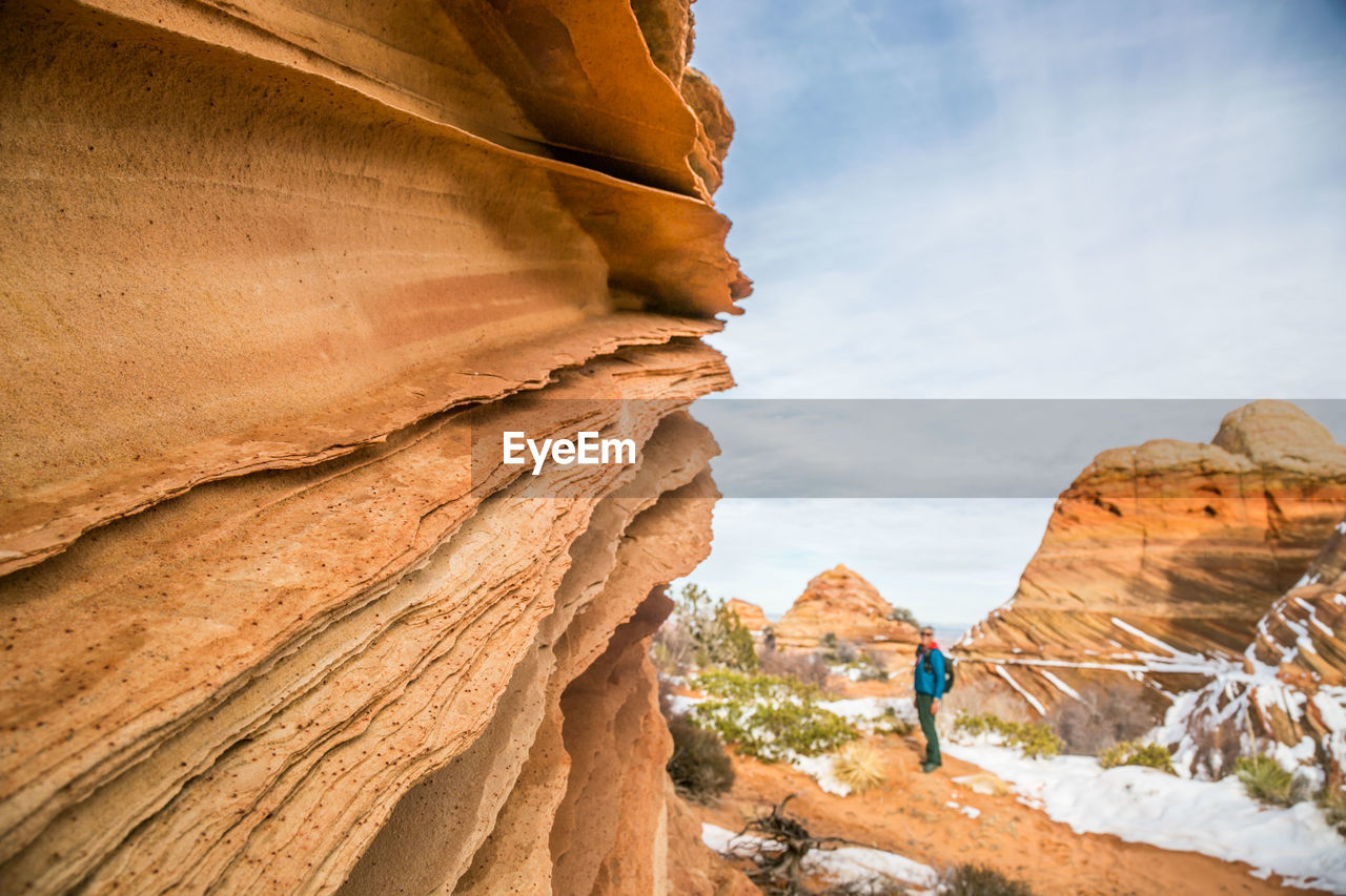 Sandstone lace rock and hiker for scale, vermilion cliffs