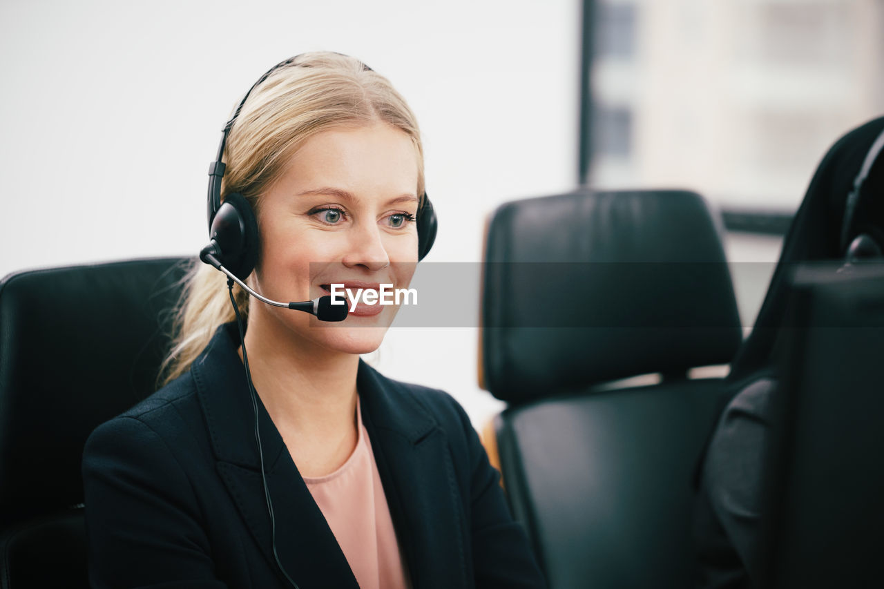 Close-up of call center employee with headset at office