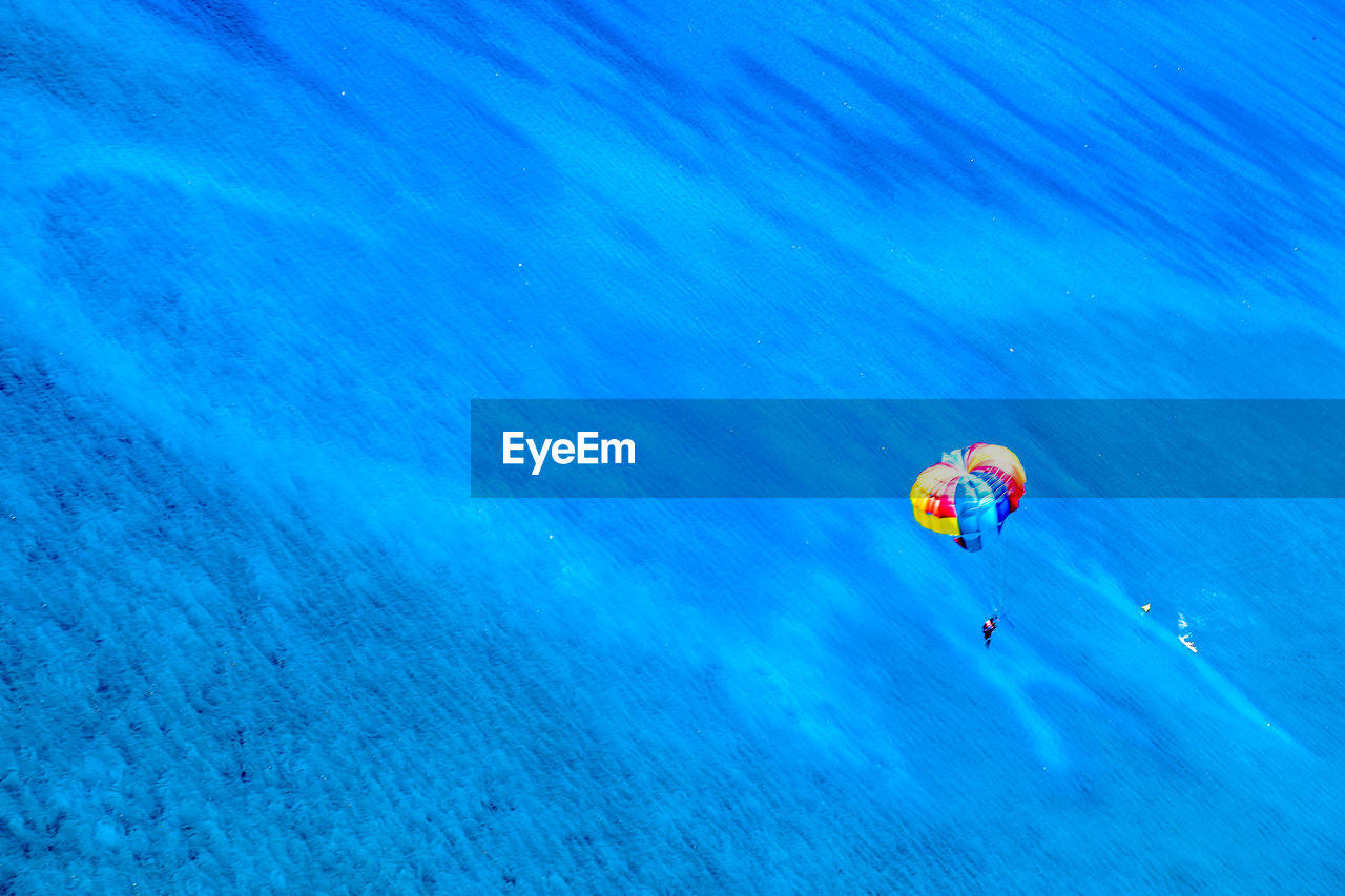 High angle view of person parasailing over sea