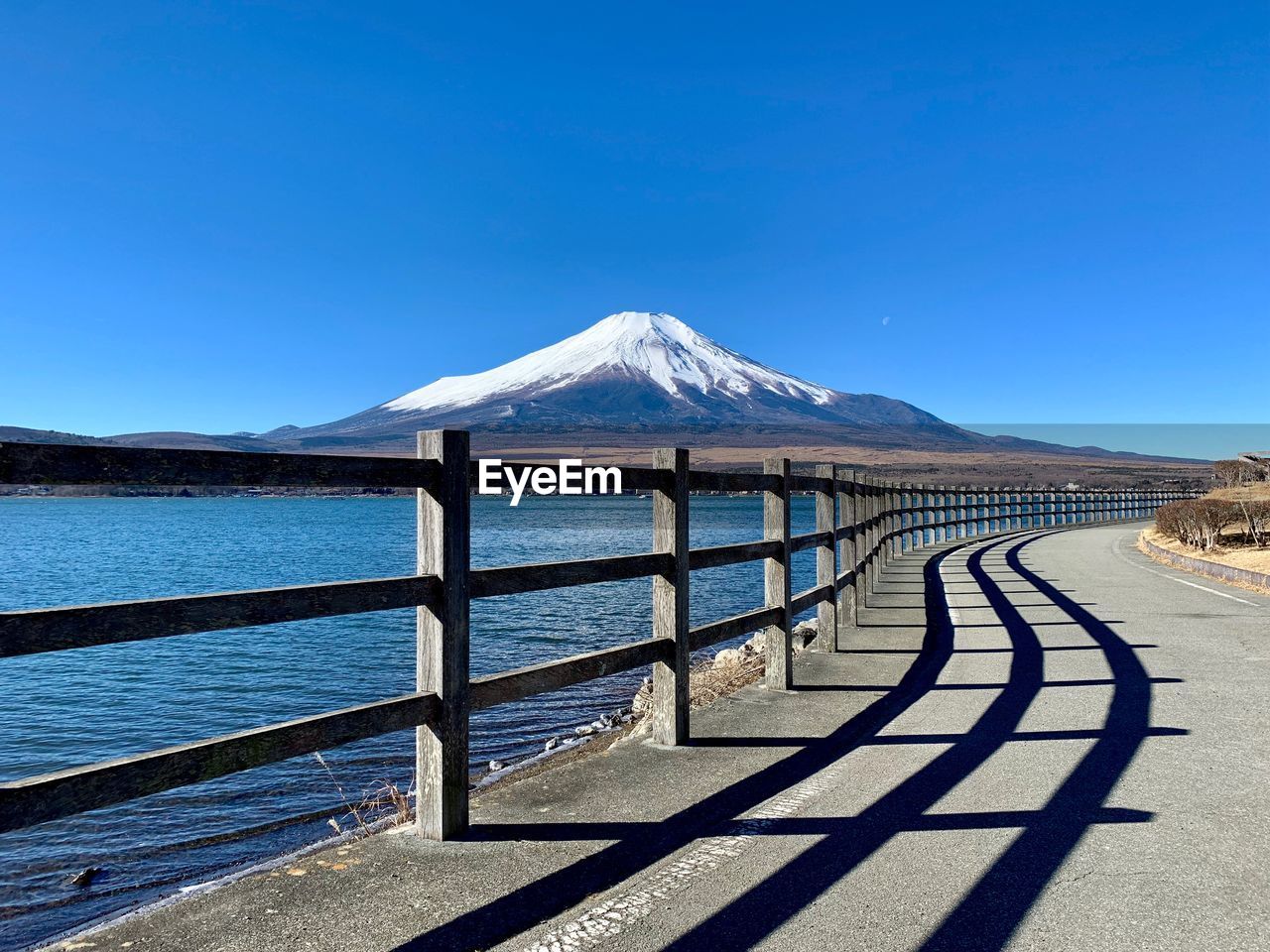 Scenic view of snowcapped mountains against clear blue sky