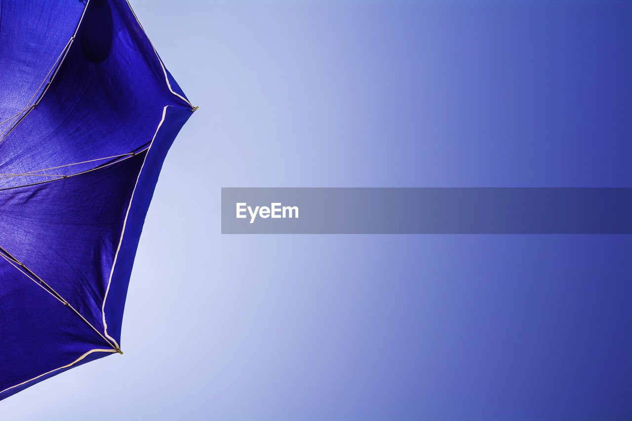 LOW ANGLE VIEW OF PURPLE AGAINST BLUE SKY
