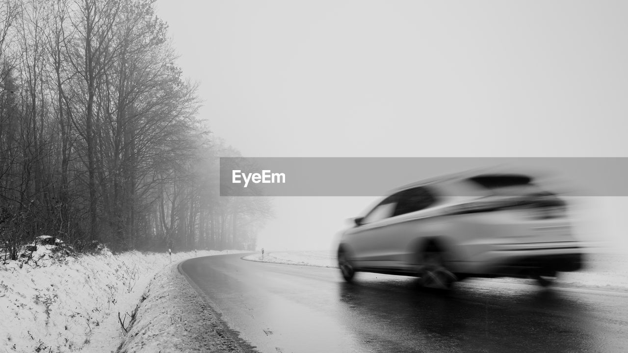 Blurred motion of car on road during winter