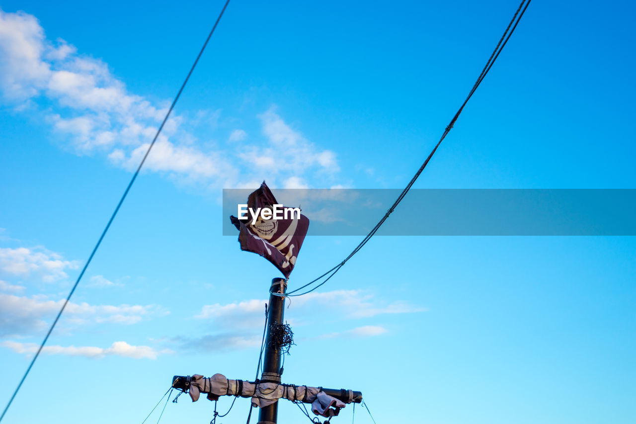 LOW ANGLE VIEW OF POWER LINES AGAINST BLUE SKY