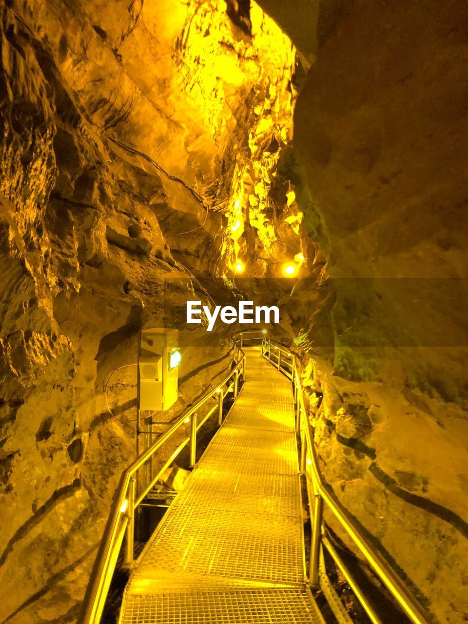 Illuminated tunnel at night