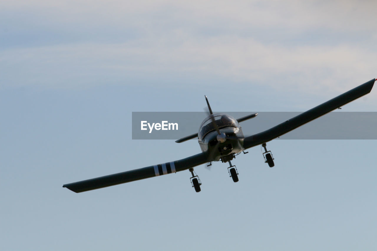 Low angle view of airplane flying against sky