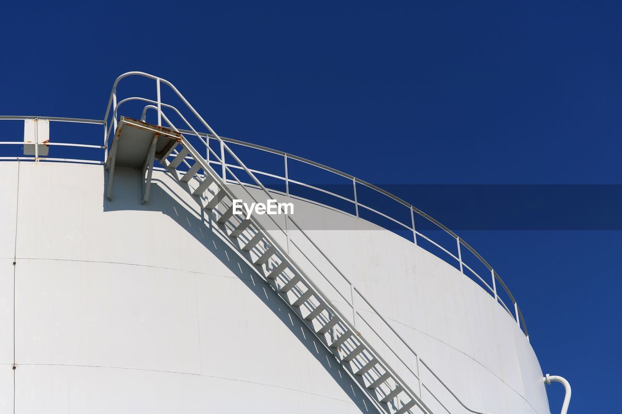 Low angle view of staircase against clear blue sky