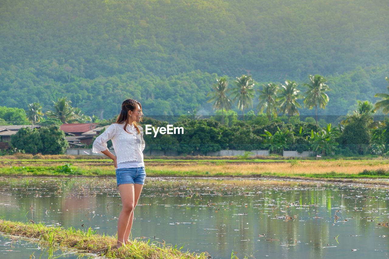 Woman standing by lake