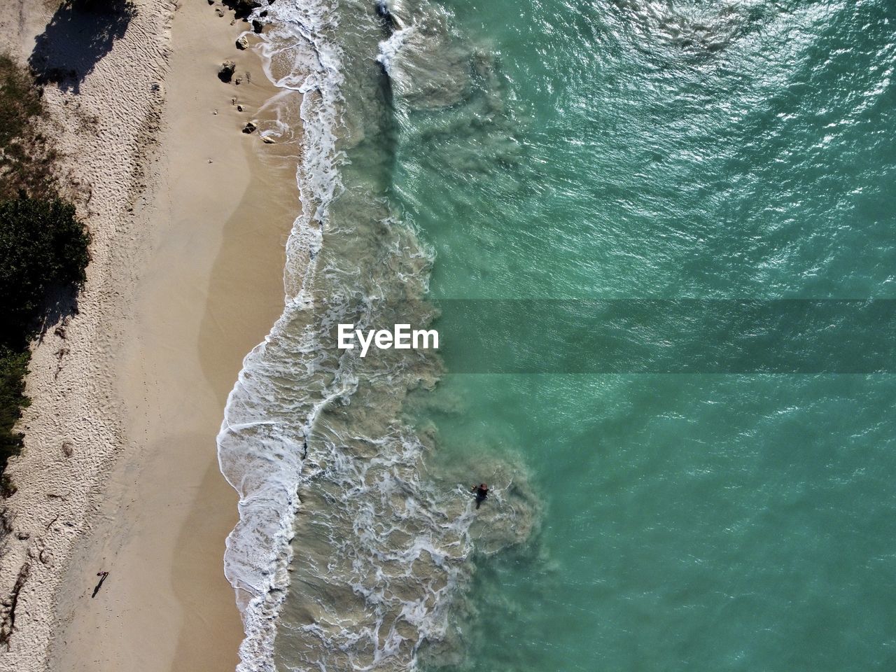 water, sea, wave, land, beach, high angle view, ocean, nature, beauty in nature, wind wave, sports, motion, day, water sports, coast, surfing, scenics - nature, terrain, outdoors, body of water, sand, shore, travel, tranquility, green, travel destinations, environment, sunlight, coastline, aerial view