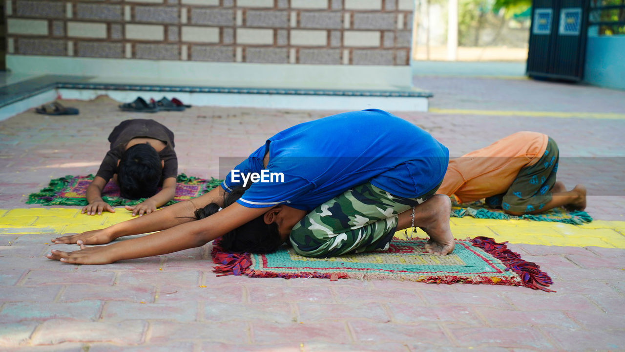 Asian girl doing gymnastic exercises or exercising in fitness class with little siblings. sport conc