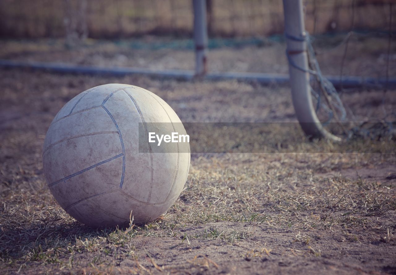 Close-up of abandoned soccer ball on field