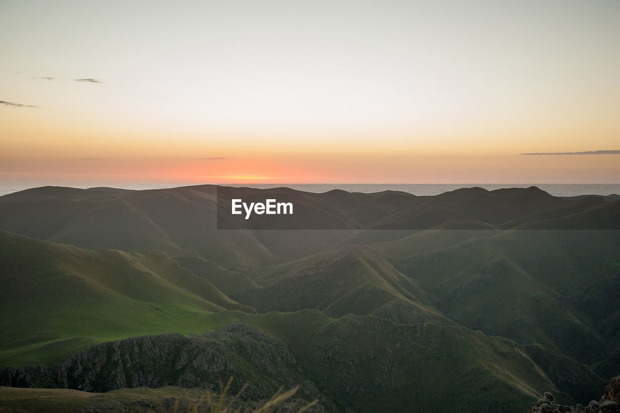 Scenic view of mountains against sky during sunset