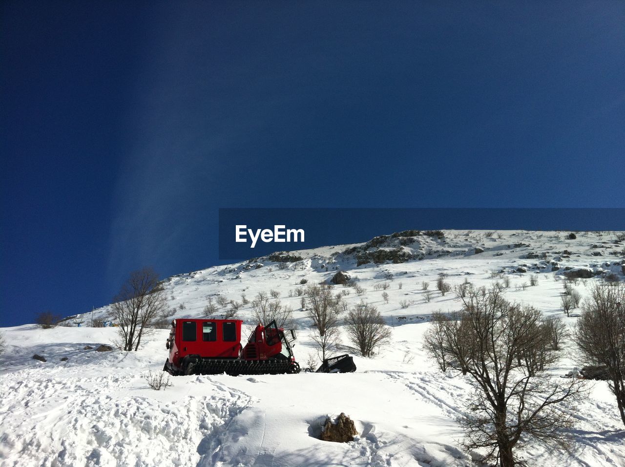 Snow covered mountain against blue sky