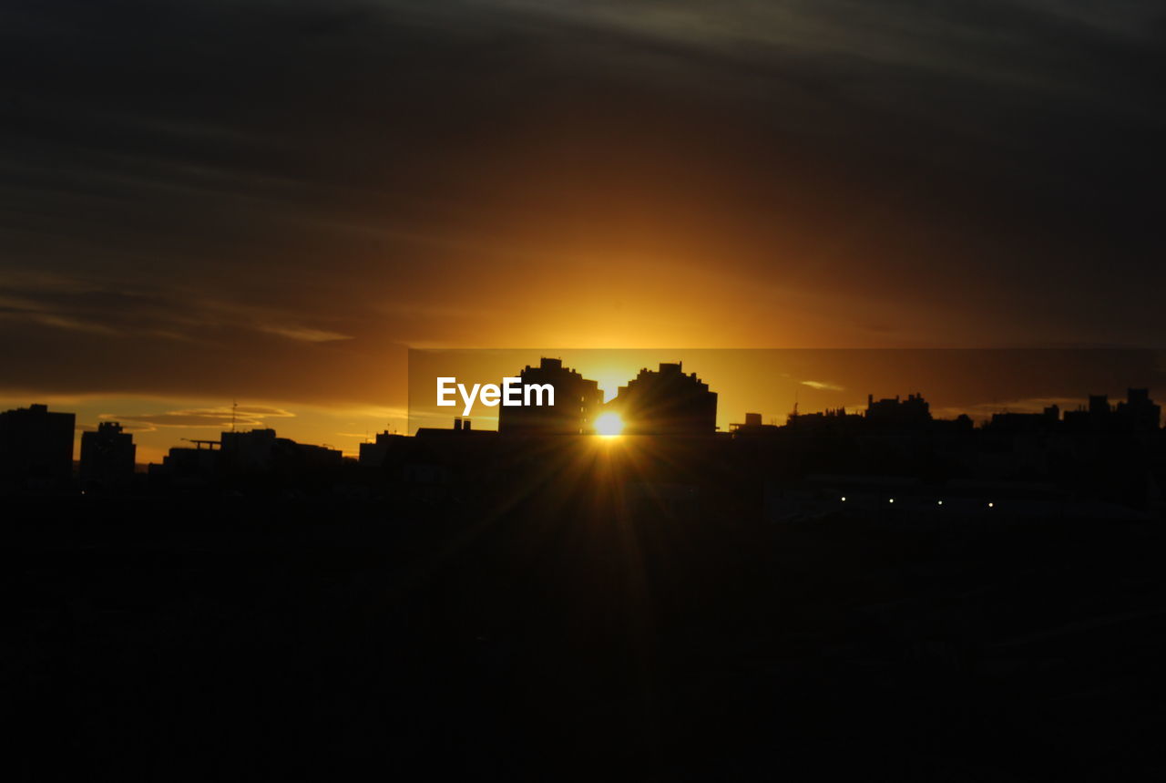 SILHOUETTE CITYSCAPE AGAINST SKY DURING SUNSET