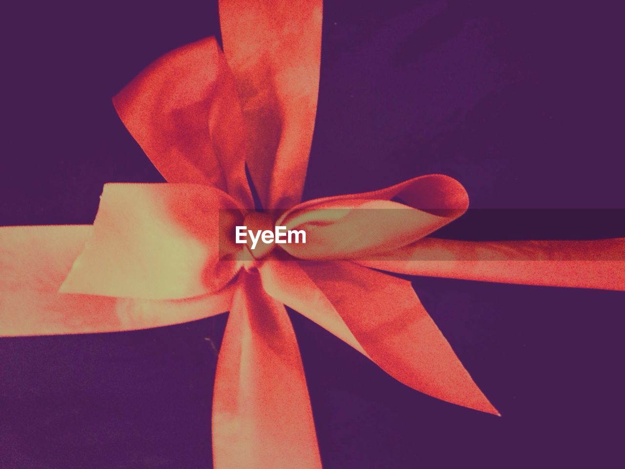 Close-up of red ribbon tied on gift