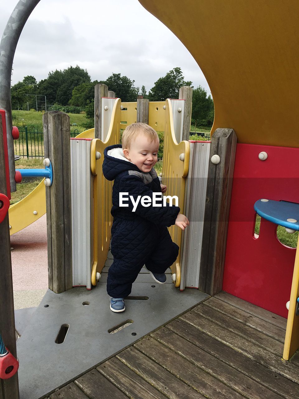 Smiling toddler playing at jungle gym