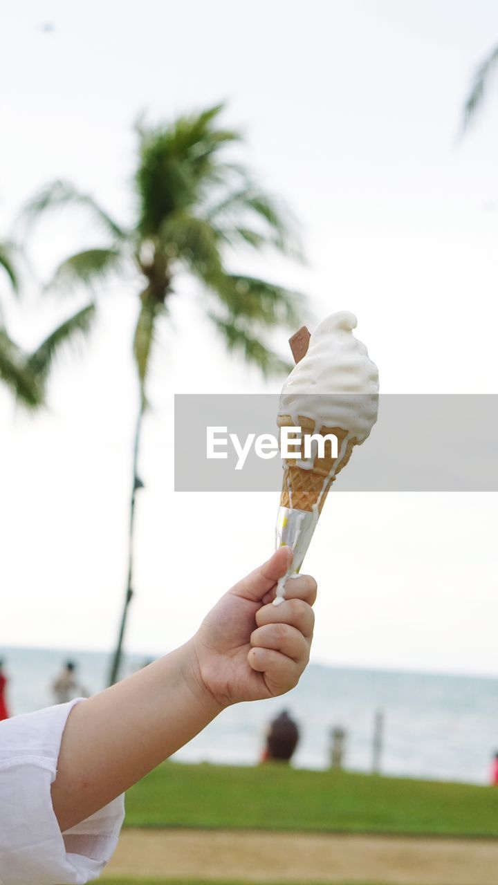 Close-up of hand holding ice cream cone