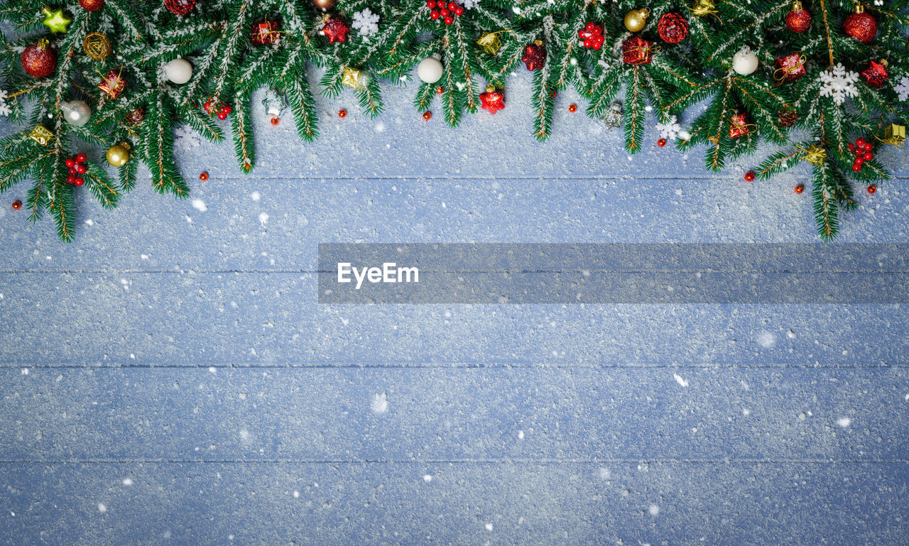 Christmas tree on table during snowfall