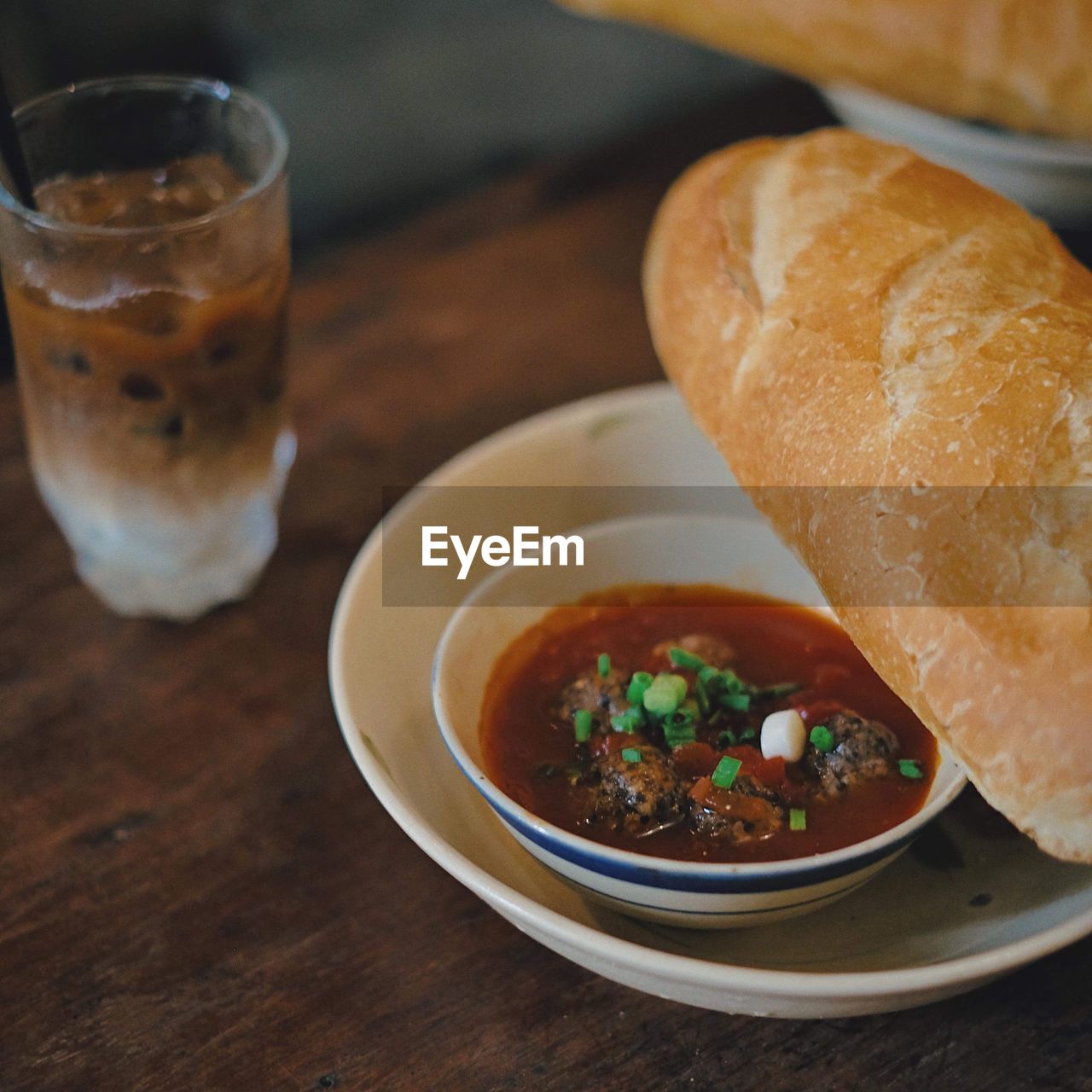 CLOSE-UP OF SOUP IN GLASS ON TABLE