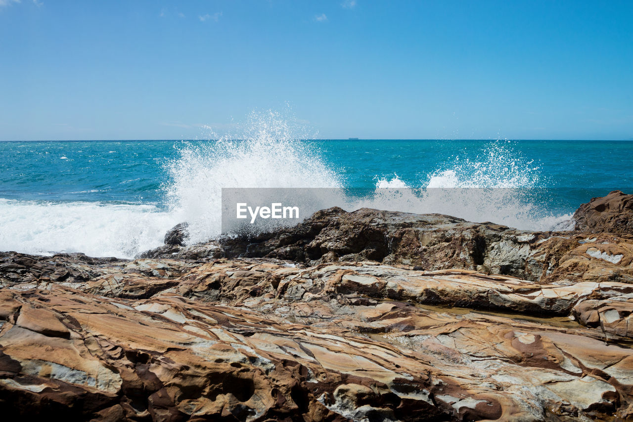 WAVES SPLASHING ON ROCKS AT SHORE