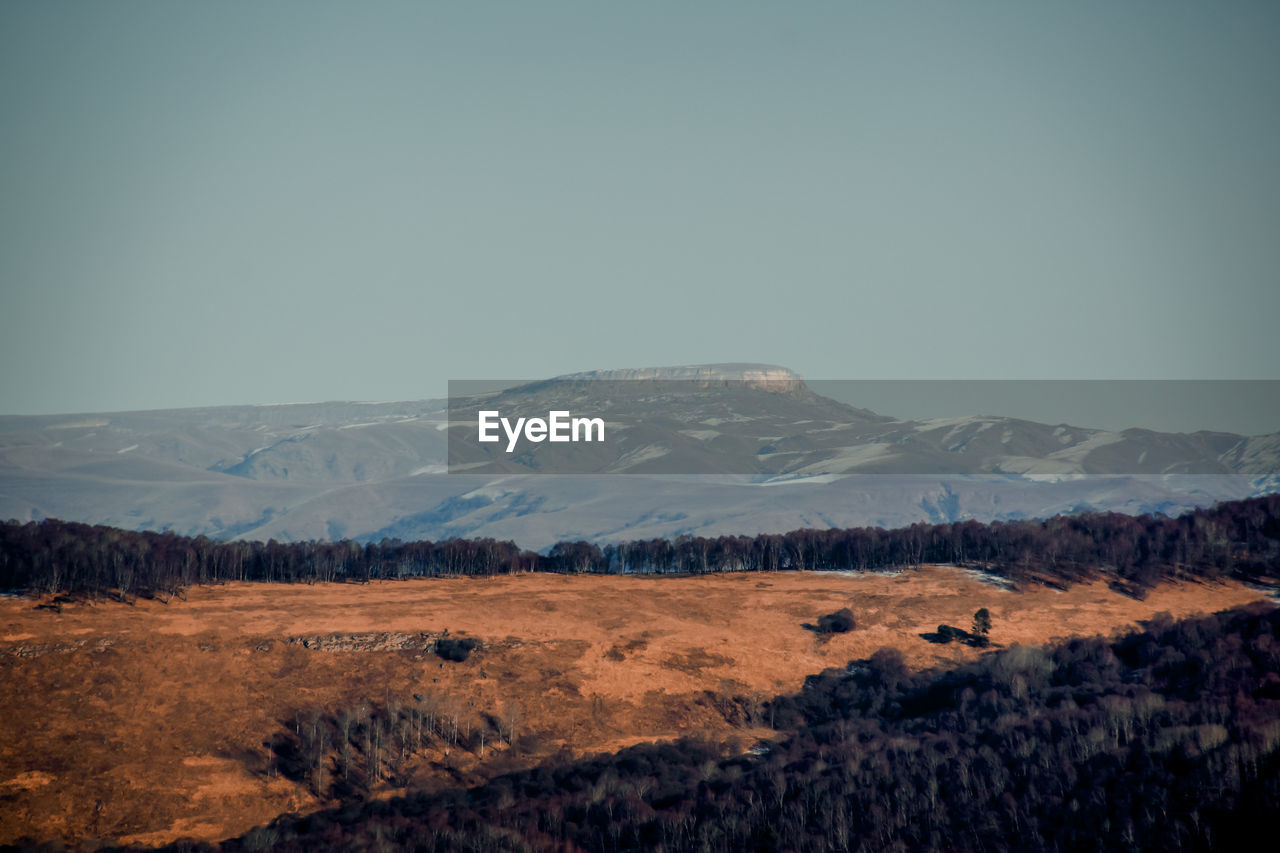 Scenic view of snowcapped mountains against clear sky