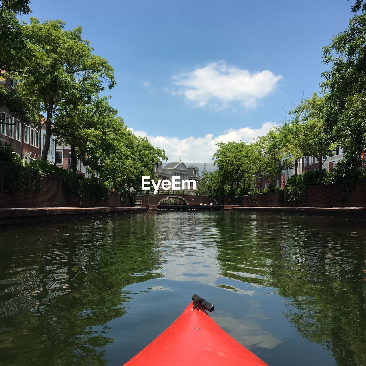 Canal against sky in city