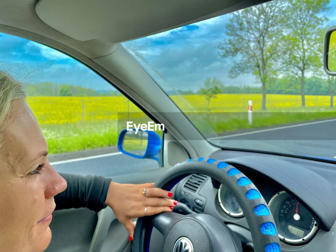transportation, mode of transportation, car, motor vehicle, one person, adult, driving, vehicle interior, vehicle, steering wheel, glass, car interior, travel, headshot, portrait, nature, automobile, mirror, women, motion, indoors, control panel, windshield, lifestyles, journey, automotive exterior, dashboard, female, wheel, window, looking, mature adult, road, on the move, day, hand, side view, land vehicle, communication, rear-view mirror, young adult