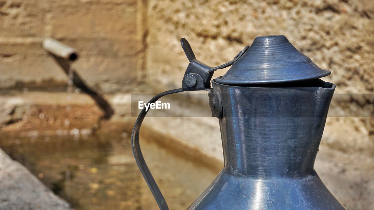 CLOSE-UP OF OLD FAUCET