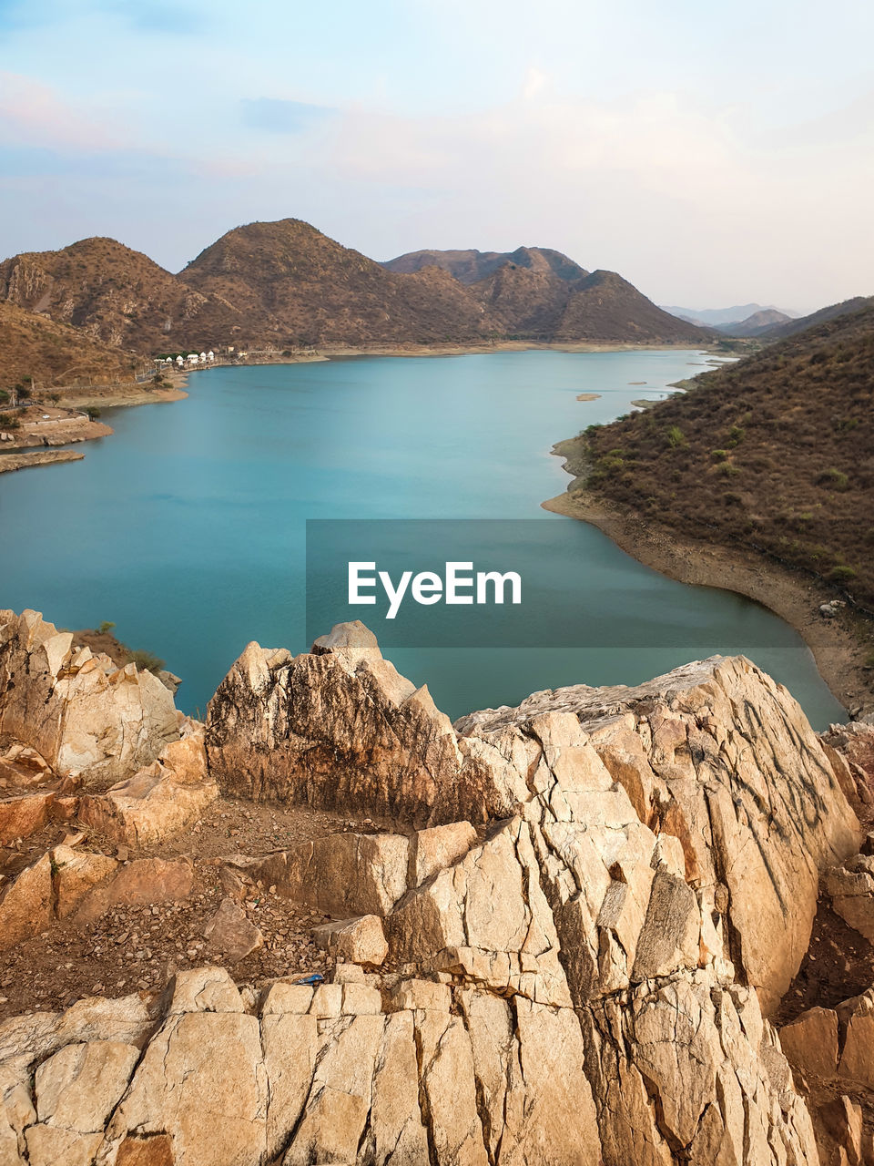 Scenic view of sea and mountains against sky