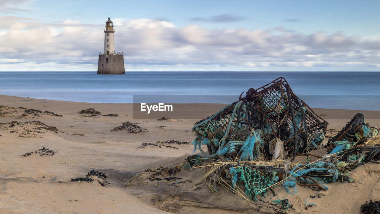 Rattray head lighthouse long exposure with marine rubbish in the foreground