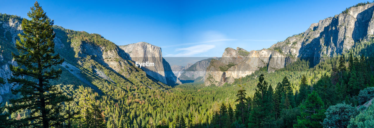 Panoramic view of mountains against blue sky