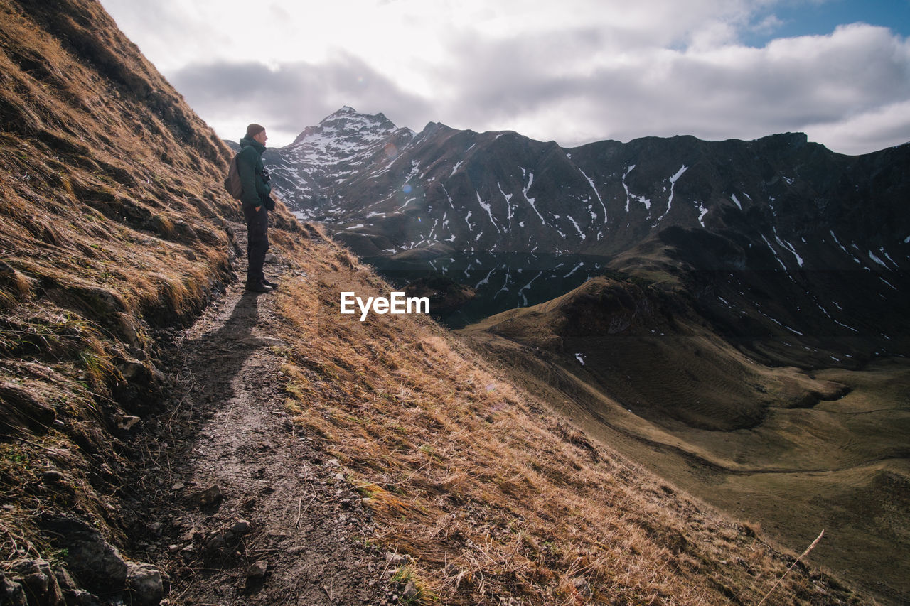 Man standing on mountain against sky