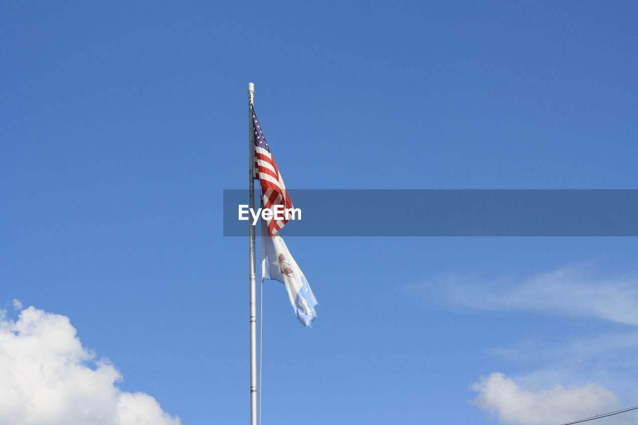 American and pineville louisiana flags waving in sky