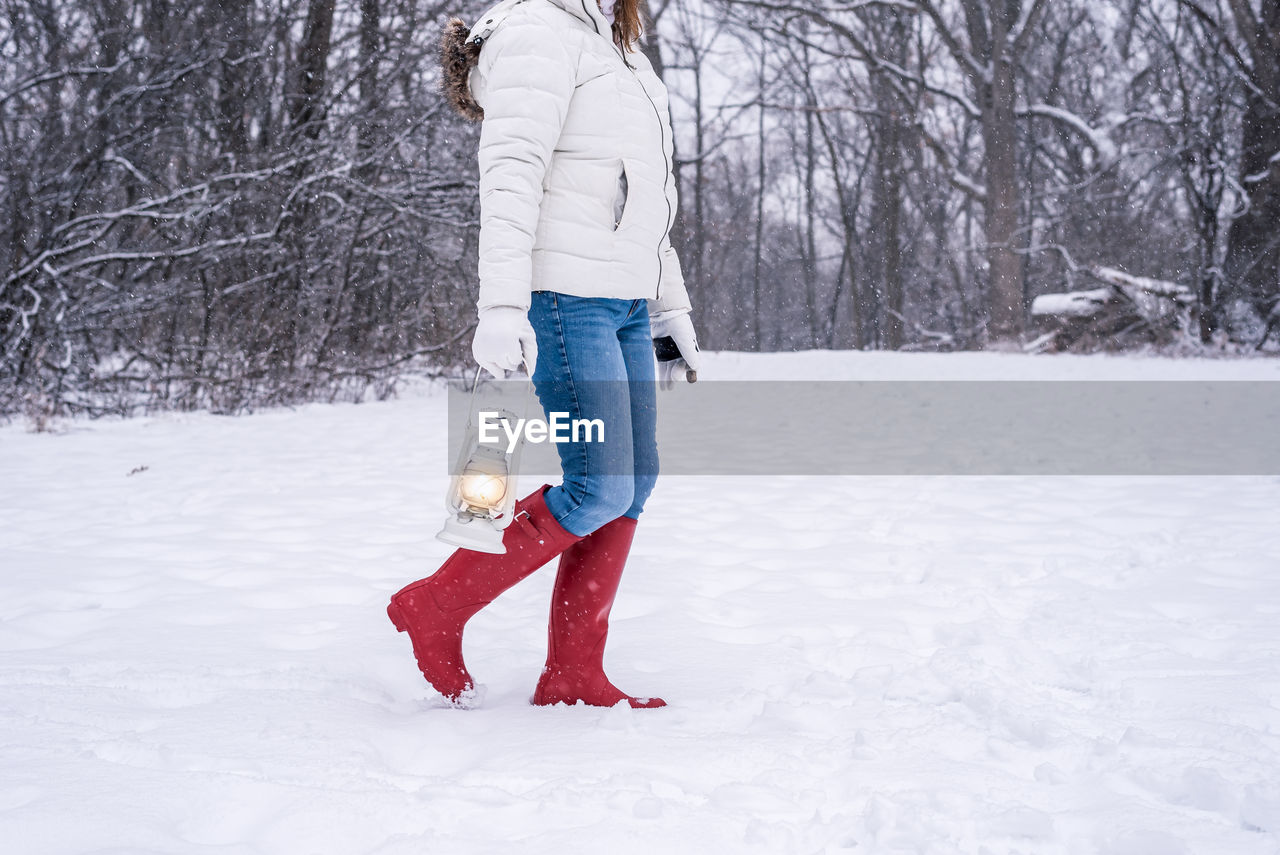 Woman standing on snow covered field