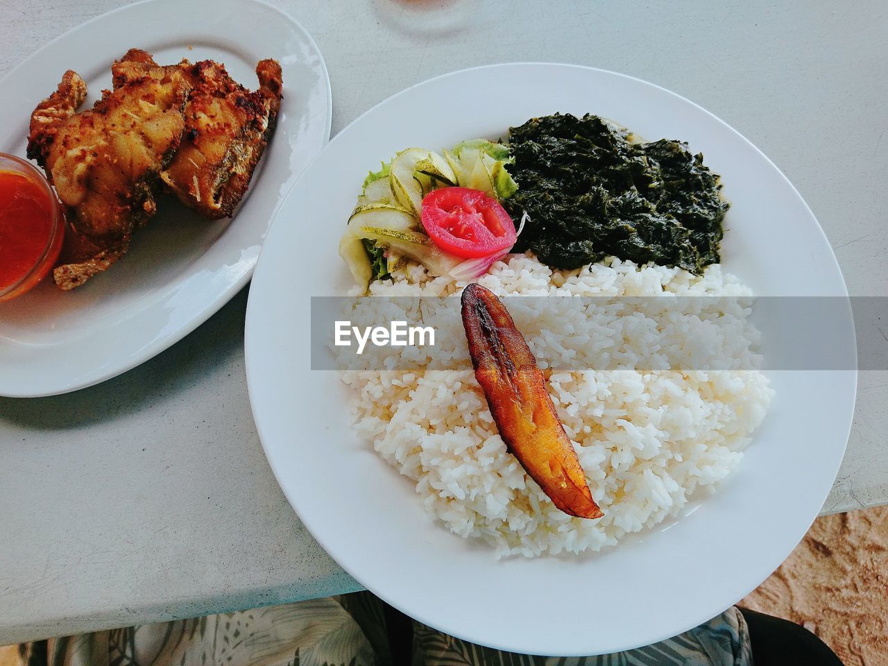 Close-up of fish with rice in plate on table