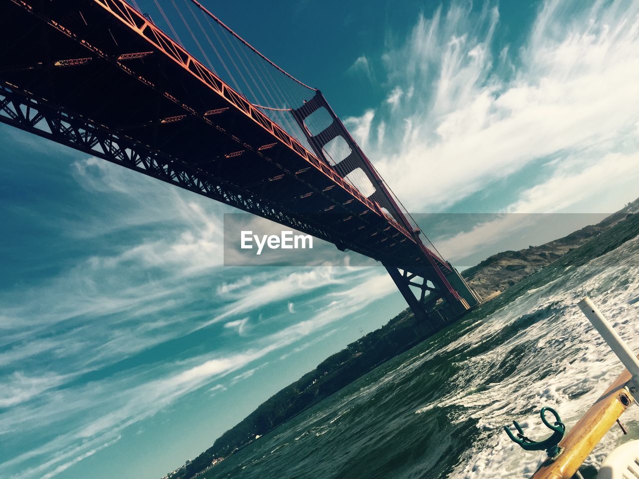 LOW ANGLE VIEW OF BRIDGE AGAINST SEA