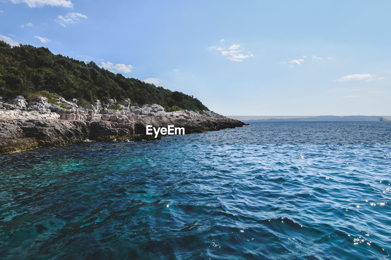 Scenic view of sea against blue sky