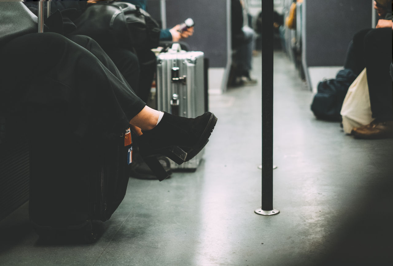 Low section of woman sitting in train