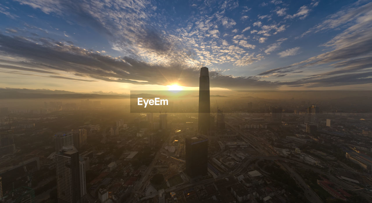 MODERN BUILDINGS AGAINST SKY DURING SUNSET