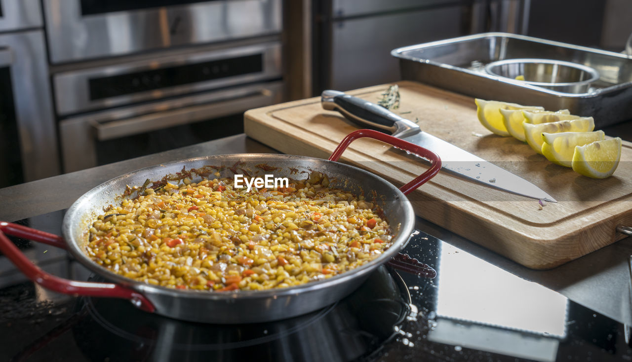 Close-up of paella in container on kitchen counter at restaurant