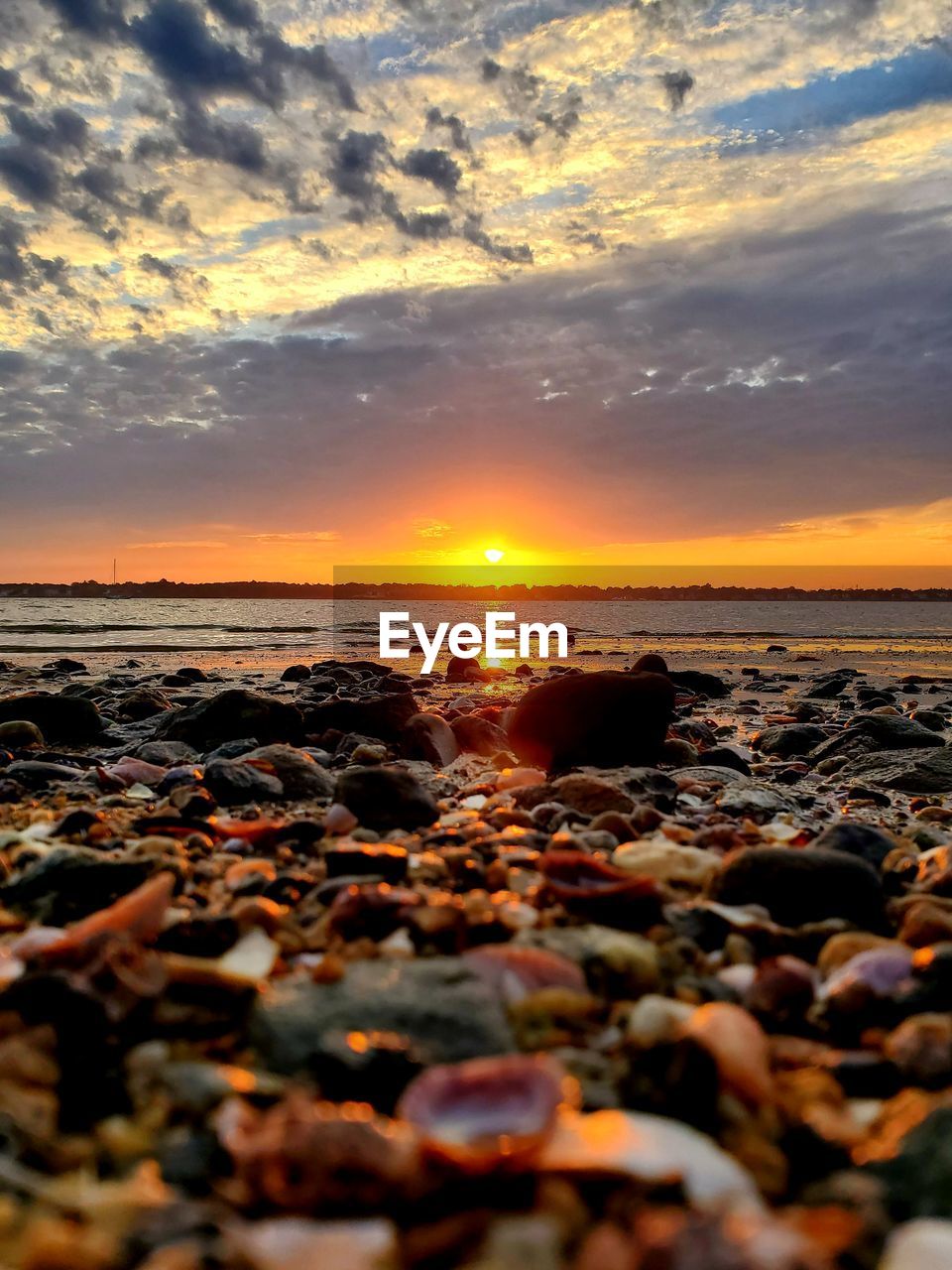 ROCKS ON BEACH AGAINST SKY DURING SUNSET