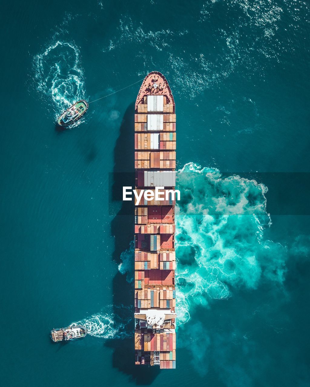 Aerial view of container ship sailing on sea 