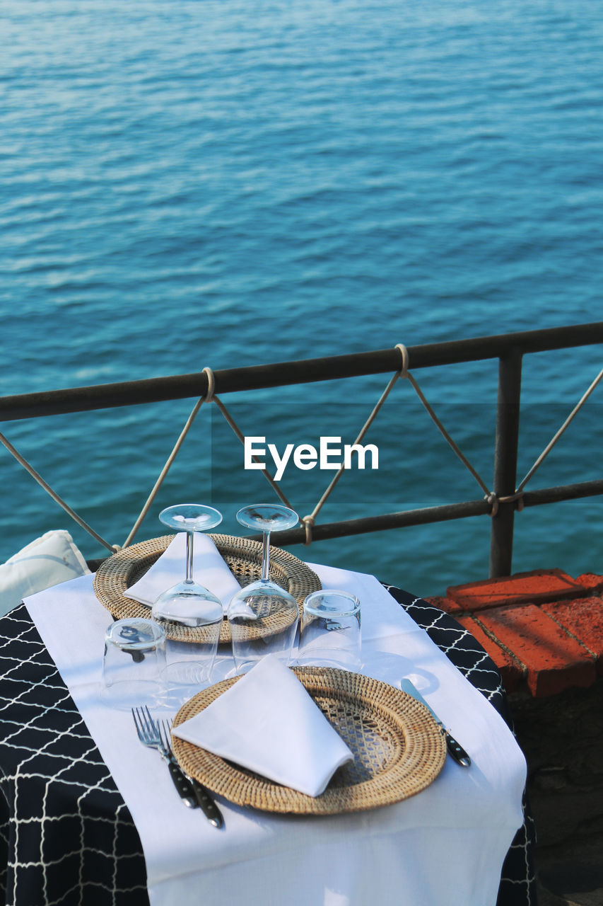 High angle view of place setting on table by railing